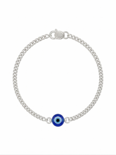 Silver bracelet with a blue evil eye charm on a white background