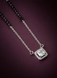 Silver necklace with a diamond pendant on a dark purple background