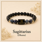 Black beaded bracelet with a Sagittarius symbol on a beige background
