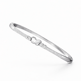 Silver bracelet with a heart charm on a white background