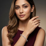 Woman wearing a silver bracelet on a dark background