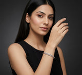 Woman wearing a silver bracelet on a dark background