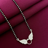 Silver necklace with a unique pendant on a maroon fabric background