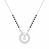 Necklace with circular pendant and black beads on a white background