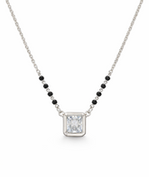 Necklace with a rectangular pendant and black beads on a white background