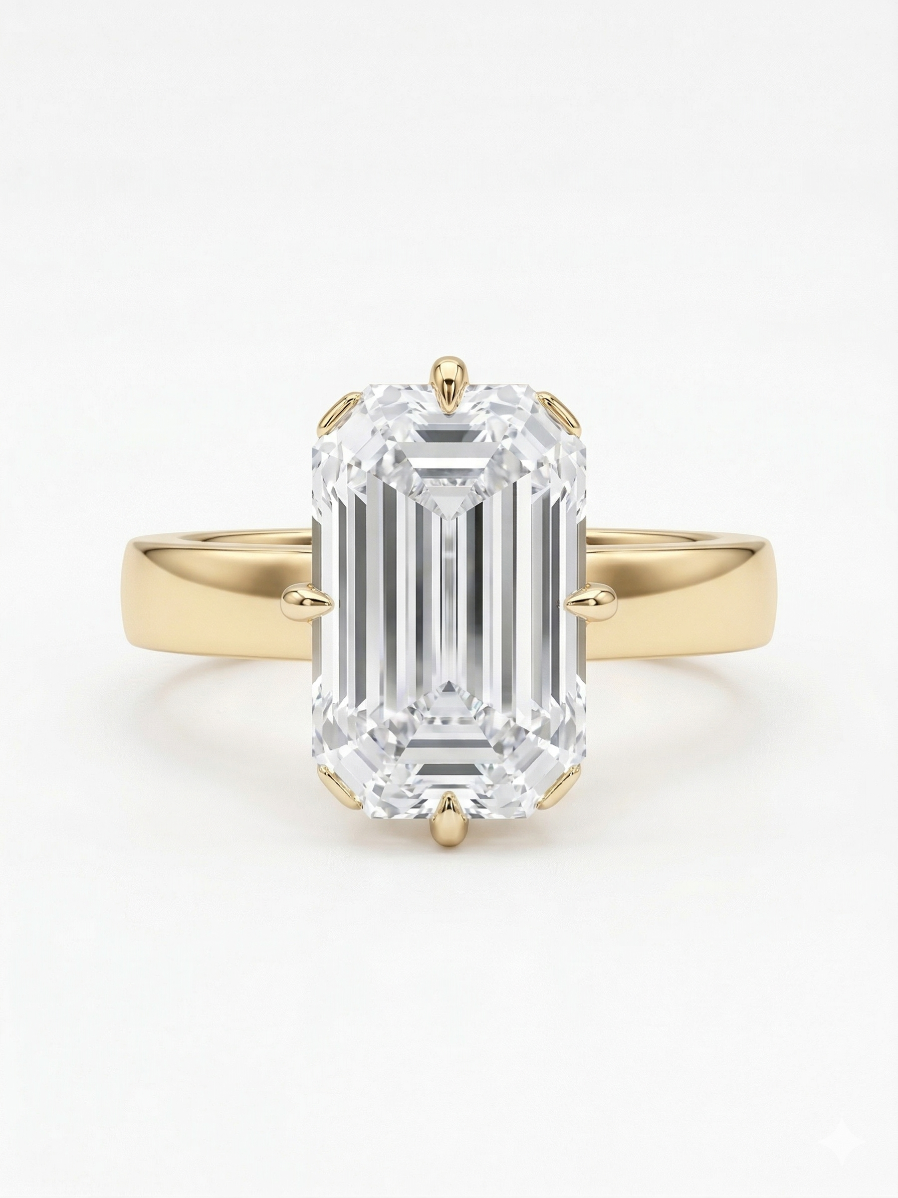Gold ring with a large emerald-cut diamond on a white background