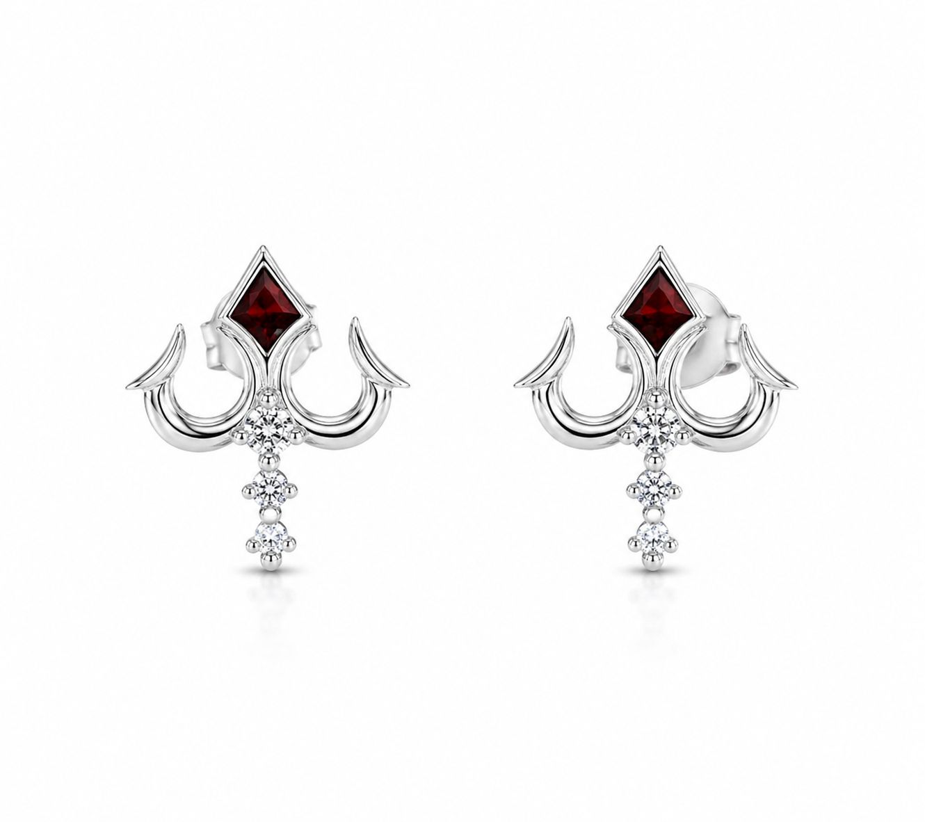 Pair of silver earrings with red gemstones on a white background