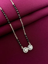 mangalsutra with a pendant on a maroon fabric background