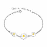 Silver bracelet with daisy flower charms on a white background