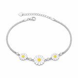 Silver bracelet with daisy flower charms on a white background