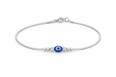 Silver payal with a blue evil eye charm on a white background