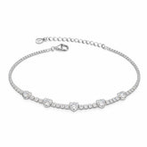 Silver bracelet with floral designs on a white background