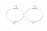 Pair of silver payal with heart charms on a white background