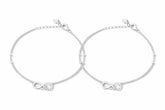 Two silver anklets with infinity symbols on a white background