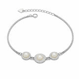 Silver bracelet with three pearls on a white background