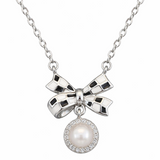 Silver bow-shaped necklace with a pearl pendant on a white background