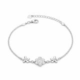 Silver bracelet with floral designs on a white background