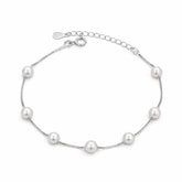 Silver bracelet with pearls on a white background