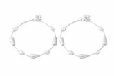 Pair of silver payal with geometric designs on a white background