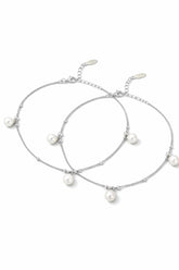 Two pearl anklets on a white background
