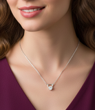 Woman wearing a silver necklace with a triangle-shaped pendant