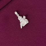 Silver pendant on a purple fabric background
