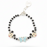 Silver Bracelet with black beads, cartoon character charms, and a butterfly charm on a white background