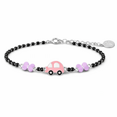 Bracelet with pink car and butterfly charms on a white background