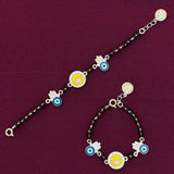 pair of silver bracelets with colorful charms on a purple background