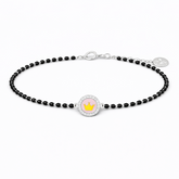 Black beaded bracelet with a round charm featuring a pink flower and gold crown on a white background.