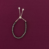 Beaded bracelet on a maroon background