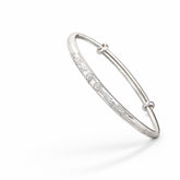 Silver bracelet with small diamonds on a white background