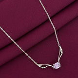 Silver necklace with a purple gemstone on a maroon fabric background