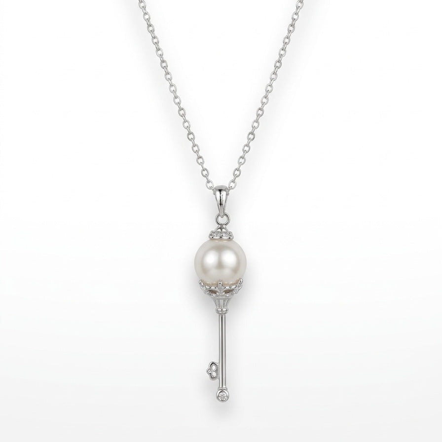 Pearl key pendant necklace on a white background