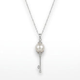 Pearl key pendant necklace on a white background