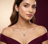 Woman wearing a gold necklace against a gradient background