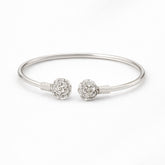 Silver bracelet with floral charm on a white background