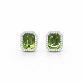 Pair of green gemstone earrings with white accents on a white background
