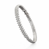 Silver kada with intricate design on a white background