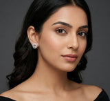 Woman wearing diamond earrings against a dark background