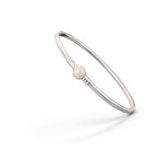 Silver bracelet with a silver pearl on a white background