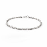 Silver braided bracelet on a white background