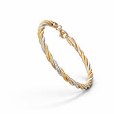 Two-tone gold bracelet on a white background