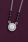 Necklace with a round pendant and black beads on a purple background