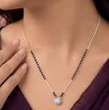 Necklace with a pendant worn by a person, focusing on the jewelry.