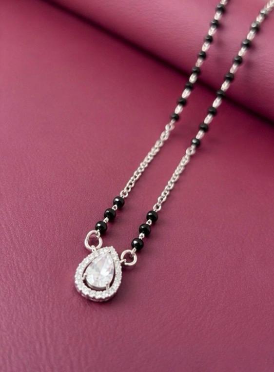Necklace with a teardrop pendant on a pink background