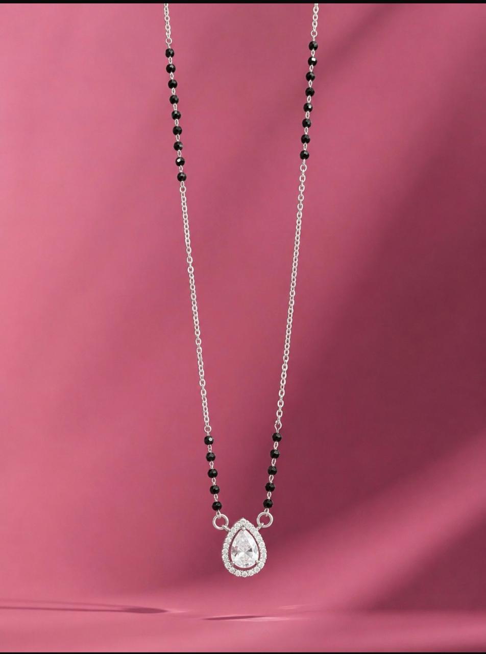 Necklace with a teardrop pendant on a pink background