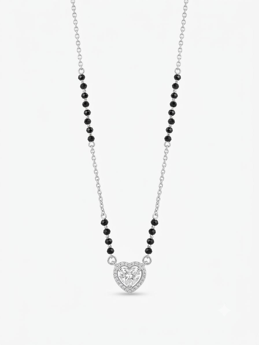 Necklace with black beads and a heart-shaped pendant on a white background