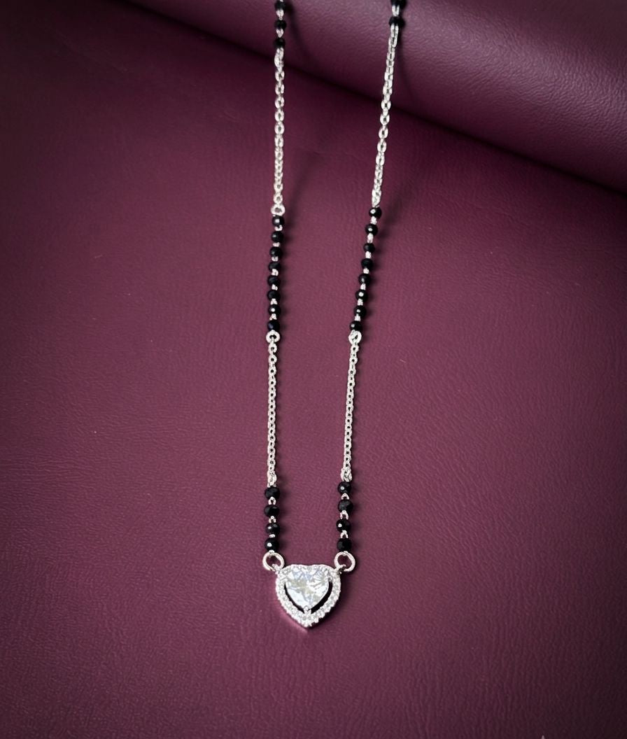 Necklace with a heart-shaped pendant on a purple background