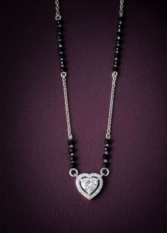 Necklace with heart-shaped diamond pendant on a dark background